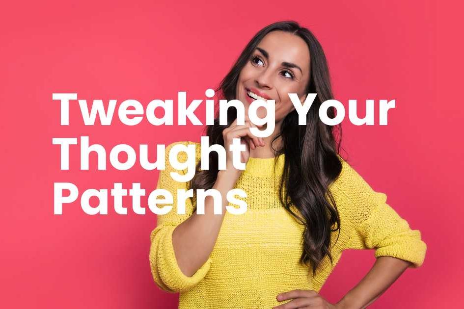 Woman in a yellow knitted top with long brown hair, smiling looking up to her right side. With a thoughtful gesture by holding her right hand to her face. Letters in white writing - Tweaking your thought patterns.